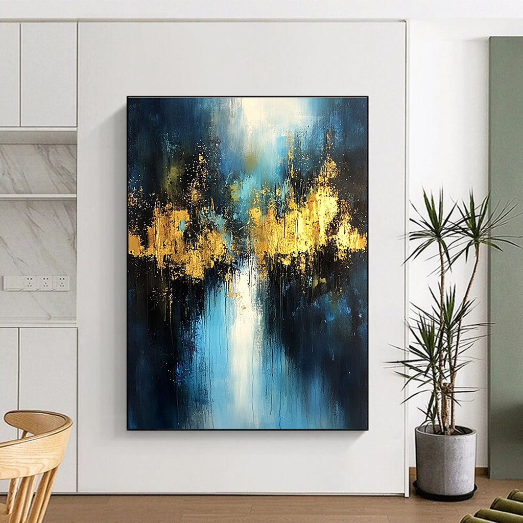 Large abstract painting with light blue and dark gold colors featuring atmospheric brushstrokes gold foil embellishments and a mysterious night scene.STSC399