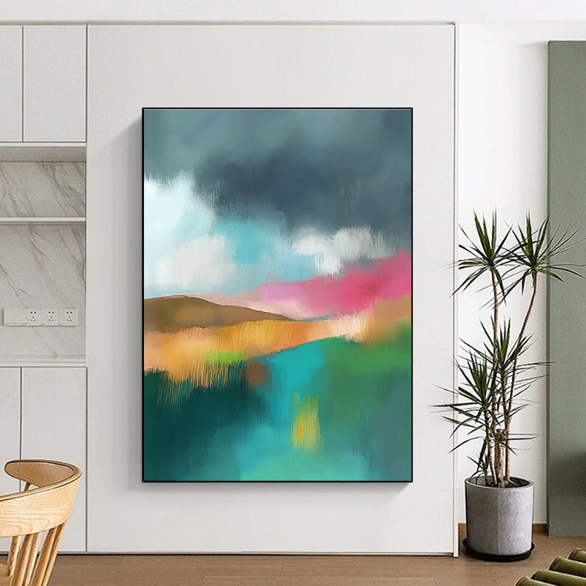 Large abstract painting featuring light teal and pink hues with a green field brown hills and a dark grey sky adorned with white clouds.STSC087