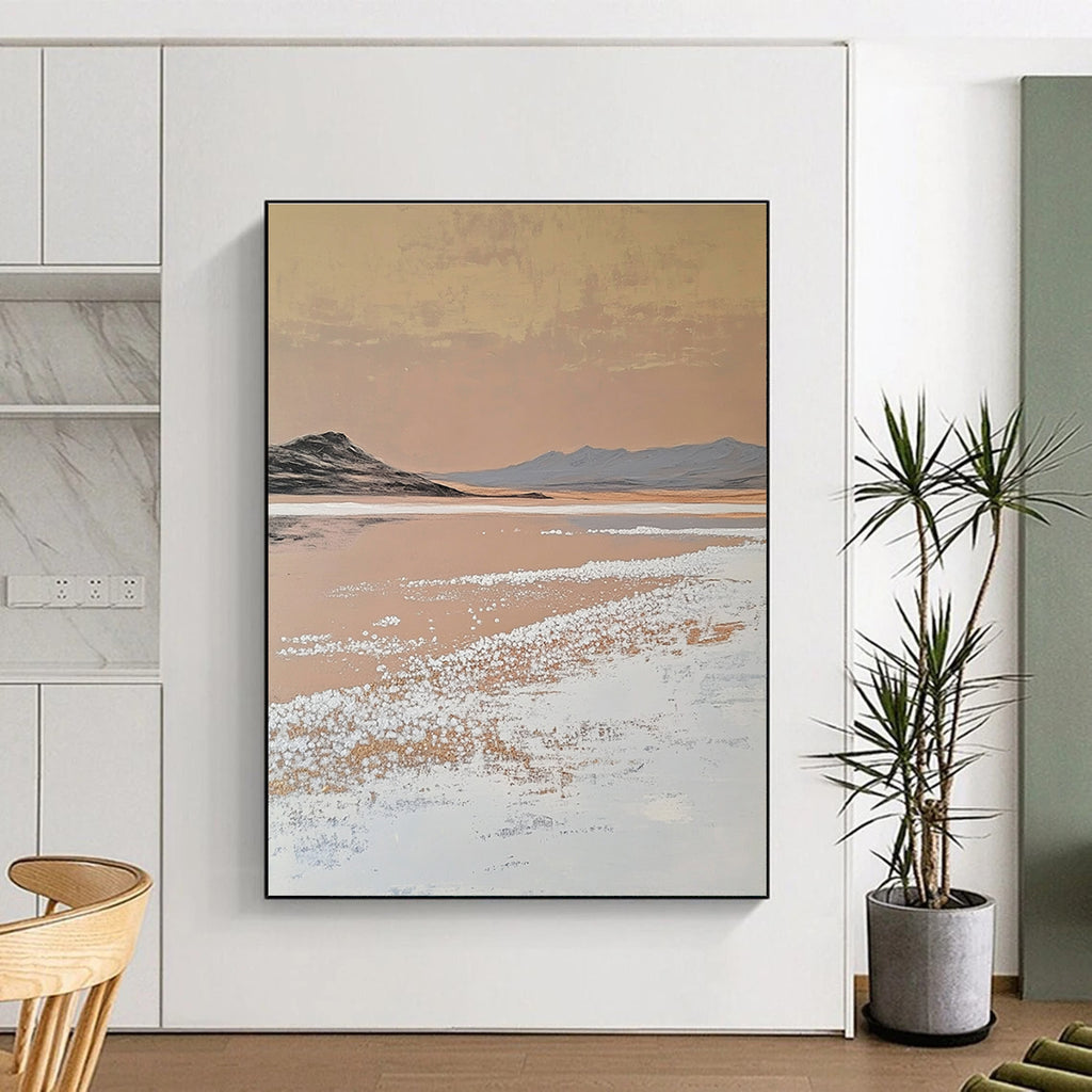 A large abstract painting features white salt crystals on a lake contrasting with textured brushstrokes in light beige and dark gold against a minimalist landscape.STSC1435