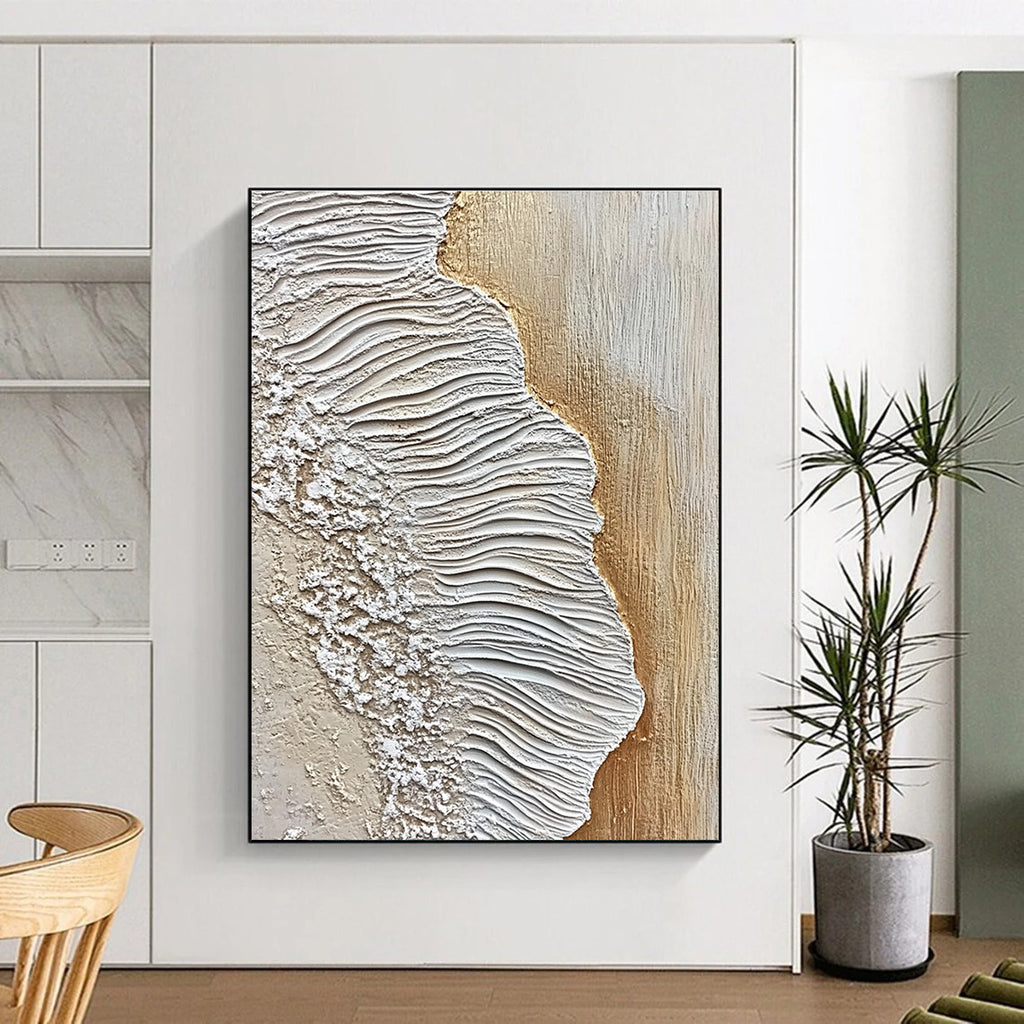 A large abstract painting featuring textured sand and waves in white and beige against an oak wood floor, embodying coastal elegance.STSC946