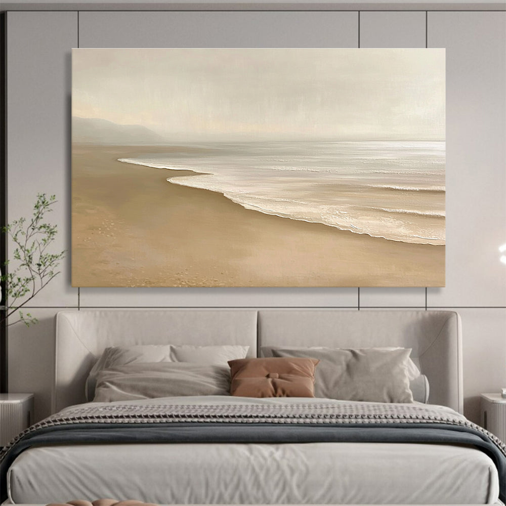 Large abstract painting featuring a serene beach with beige and white tones capturing gentle waves and soft sand in a tranquil setting.SC424