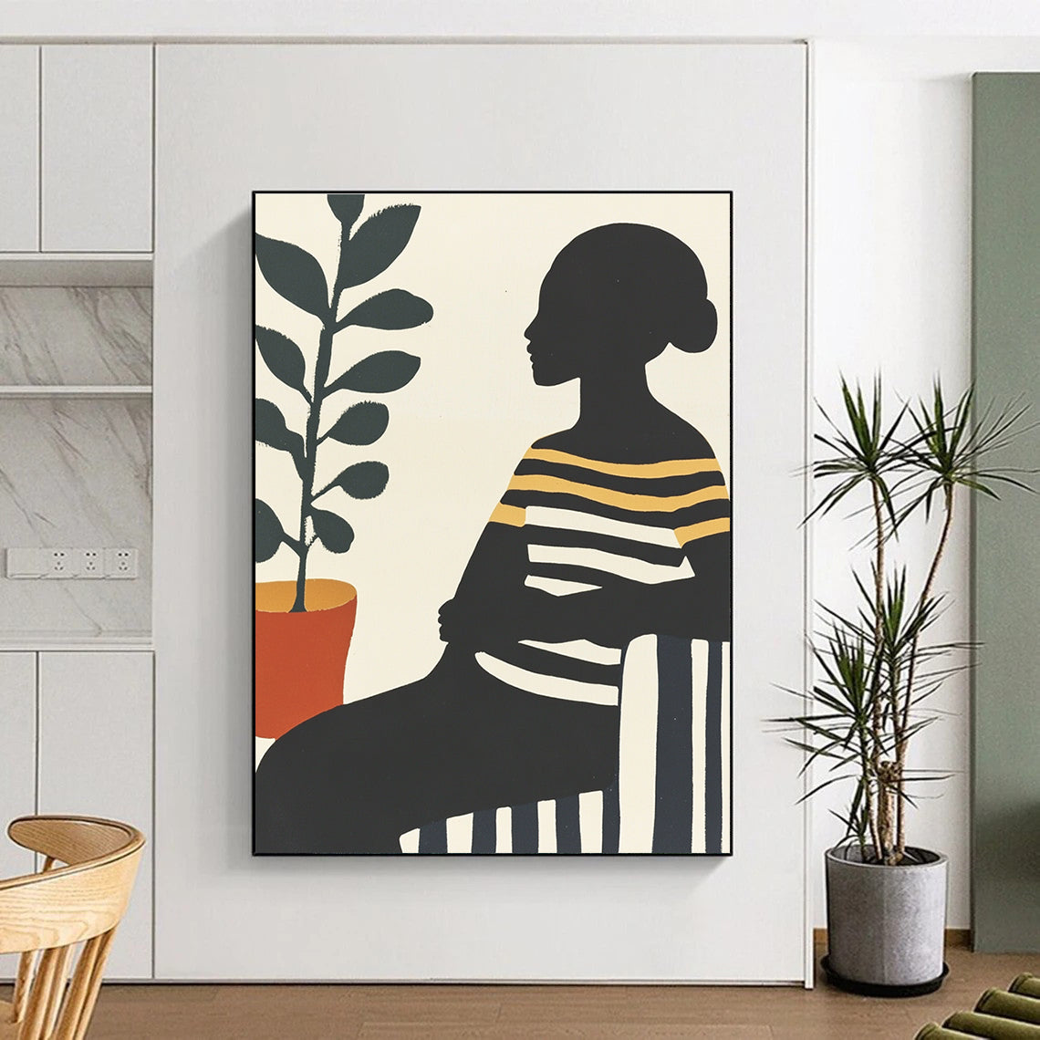 Large abstract painting featuring an African woman on a striped sofa with silhouettes and vibrant colors complemented by a pot of green leaves.STSC537