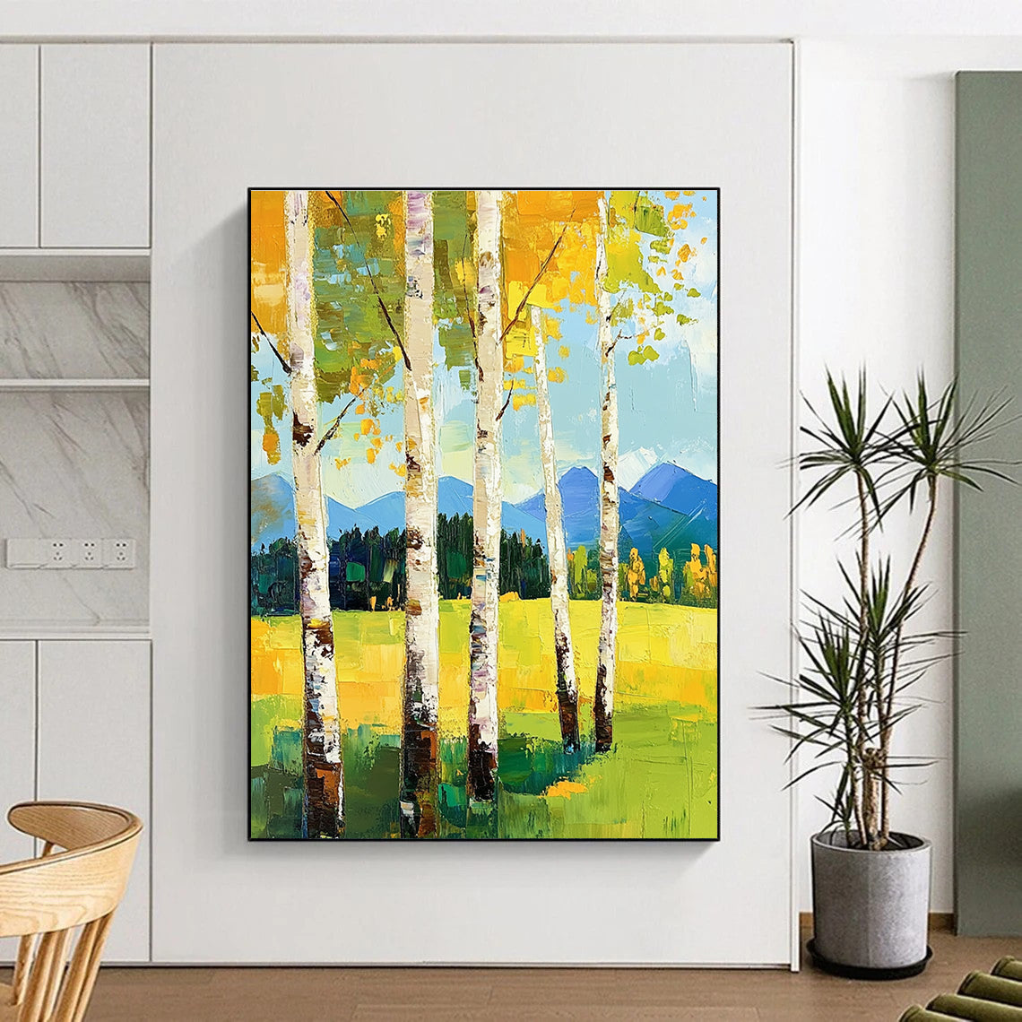 Large abstract painting featuring birch trees in spring vibrant greens and yellows with mountains in the background and thick expressive brush strokes.STSC871
