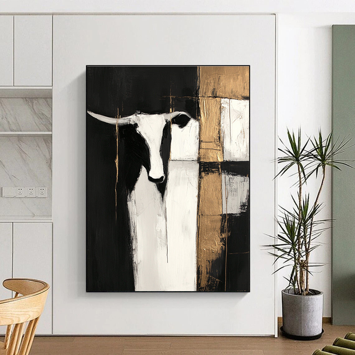 Large abstract painting in black and white with gold accents featuring cow shapes and wood planks on a dark background with visible brush strokes.STSC223