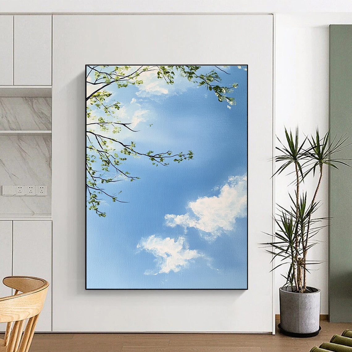 A large abstract painting capturing a serene sky with branches and leaves featuring delicate brushstrokes and soft colors for a tranquil atmosphere.STSC1195