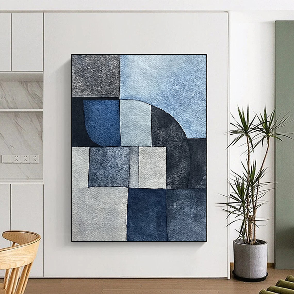Large abstract painting features minimalistic gray-blue watercolor cubist shapes depicting sandstone rocks in a serene desert landscape.STSC240