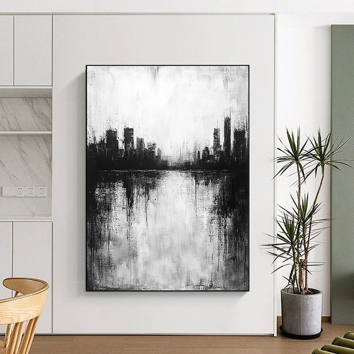 Large abstract painting in black and white with city silhouette and lake reflection evokes calmness and mystery through minimalist heavy brushstrokes.STSC215