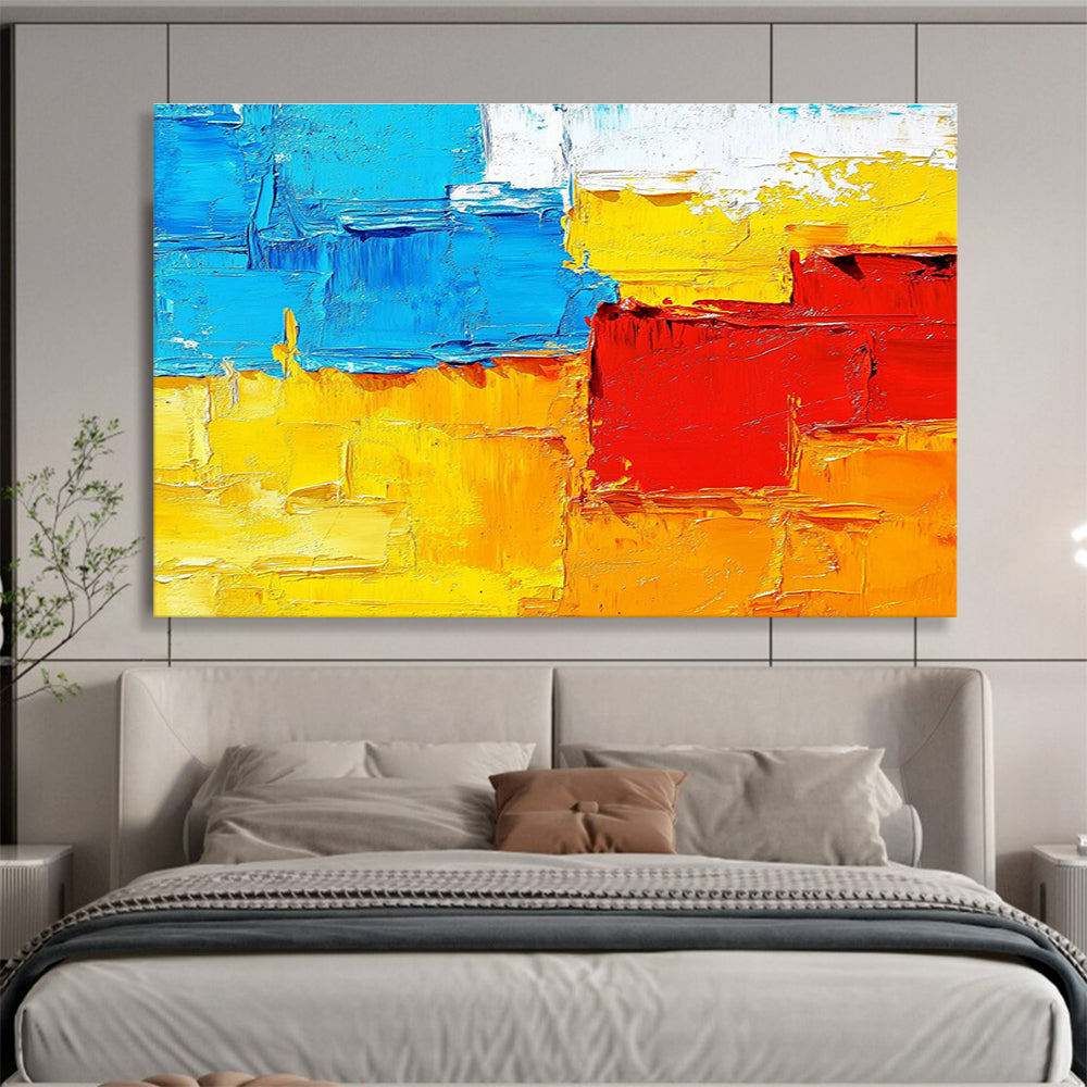 Large abstract painting featuring textured impasto brushstrokes in warm sunset tones of orange red yellow and blue.SC261