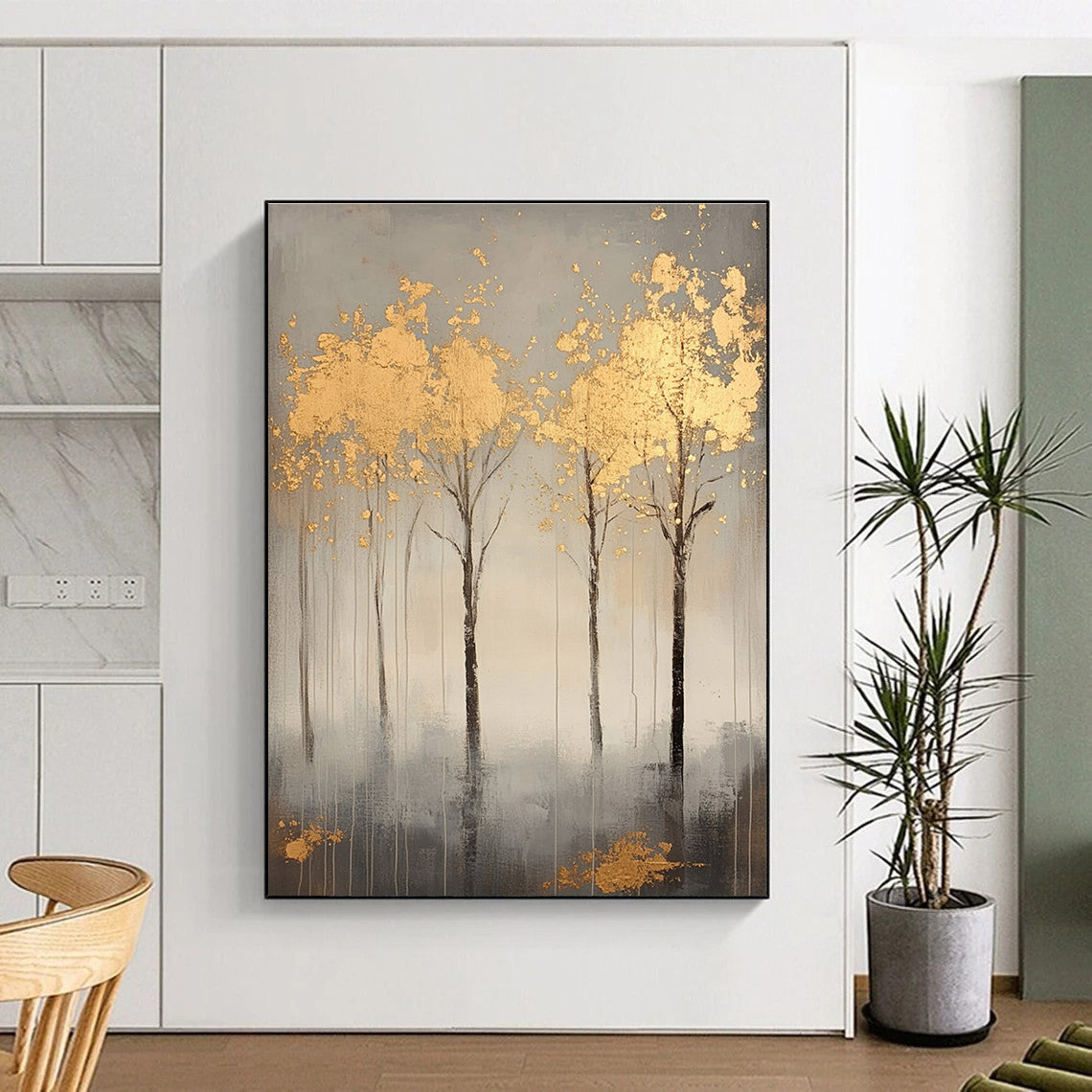 A large abstract painting featuring serene gray trees with gold leaf accents creating a tranquil atmosphere and evoking nature's beauty.STSC1174