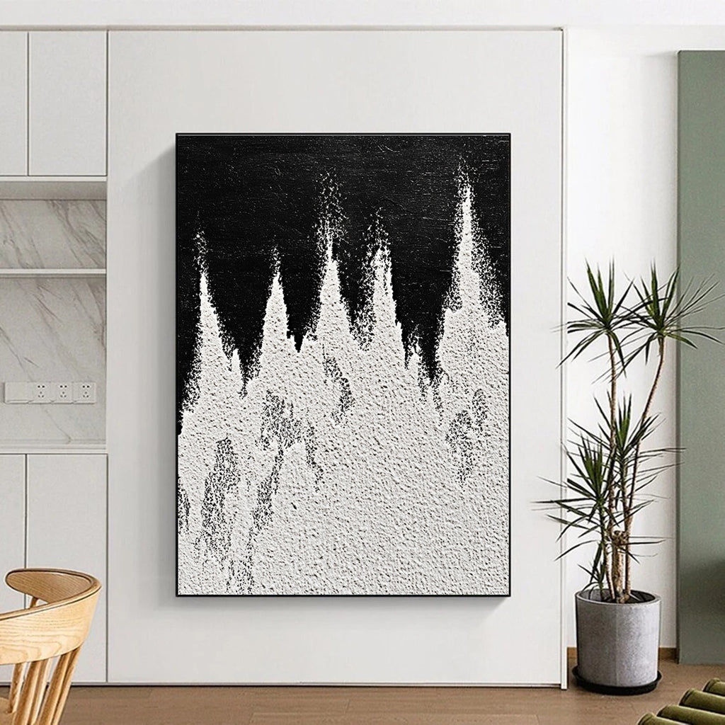 A large abstract painting featuring white powder on a black background with textured mountain ranges in playful gray and white tones capturing sharp edges.STSC1487