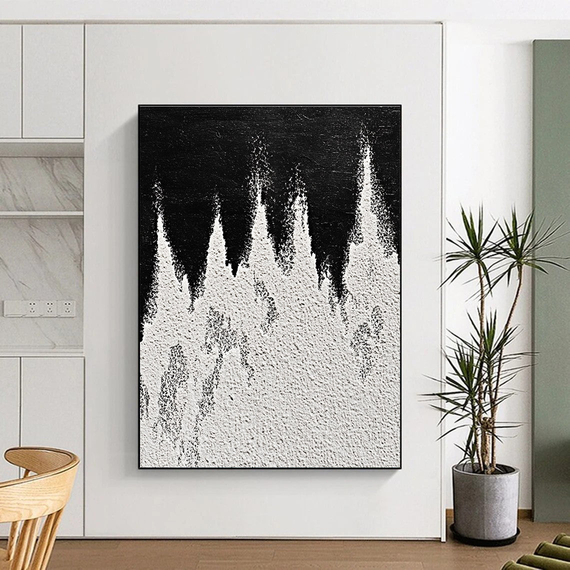 A large abstract painting featuring white powder on a black background with textured mountain ranges in playful gray and white tones capturing sharp edges.STSC1487