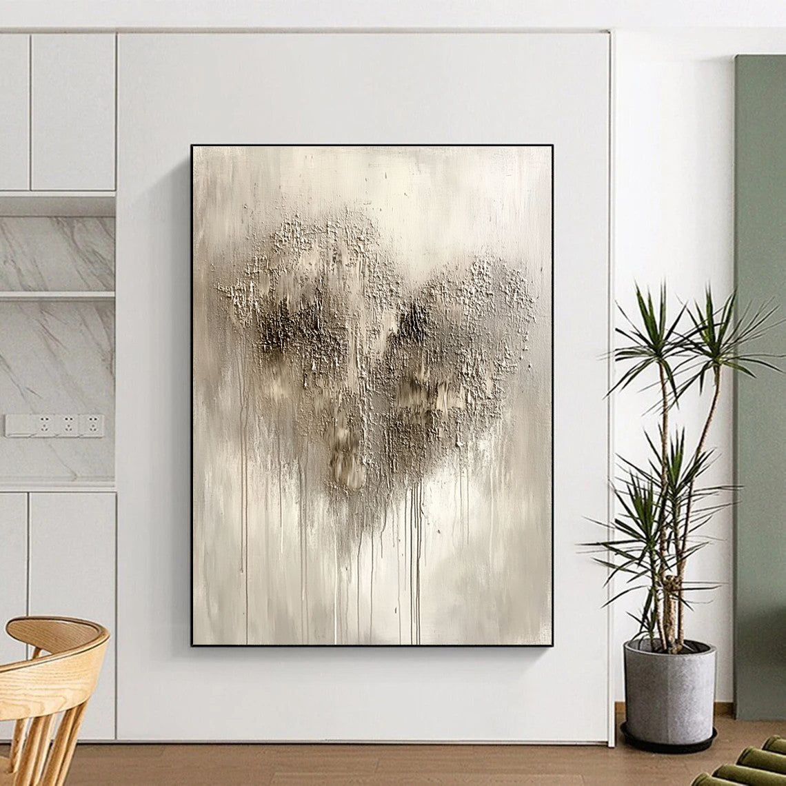 Large abstract painting in silvery gray with impasto texture featuring a heart-shaped pattern and accents of black and dark brown.STSC519