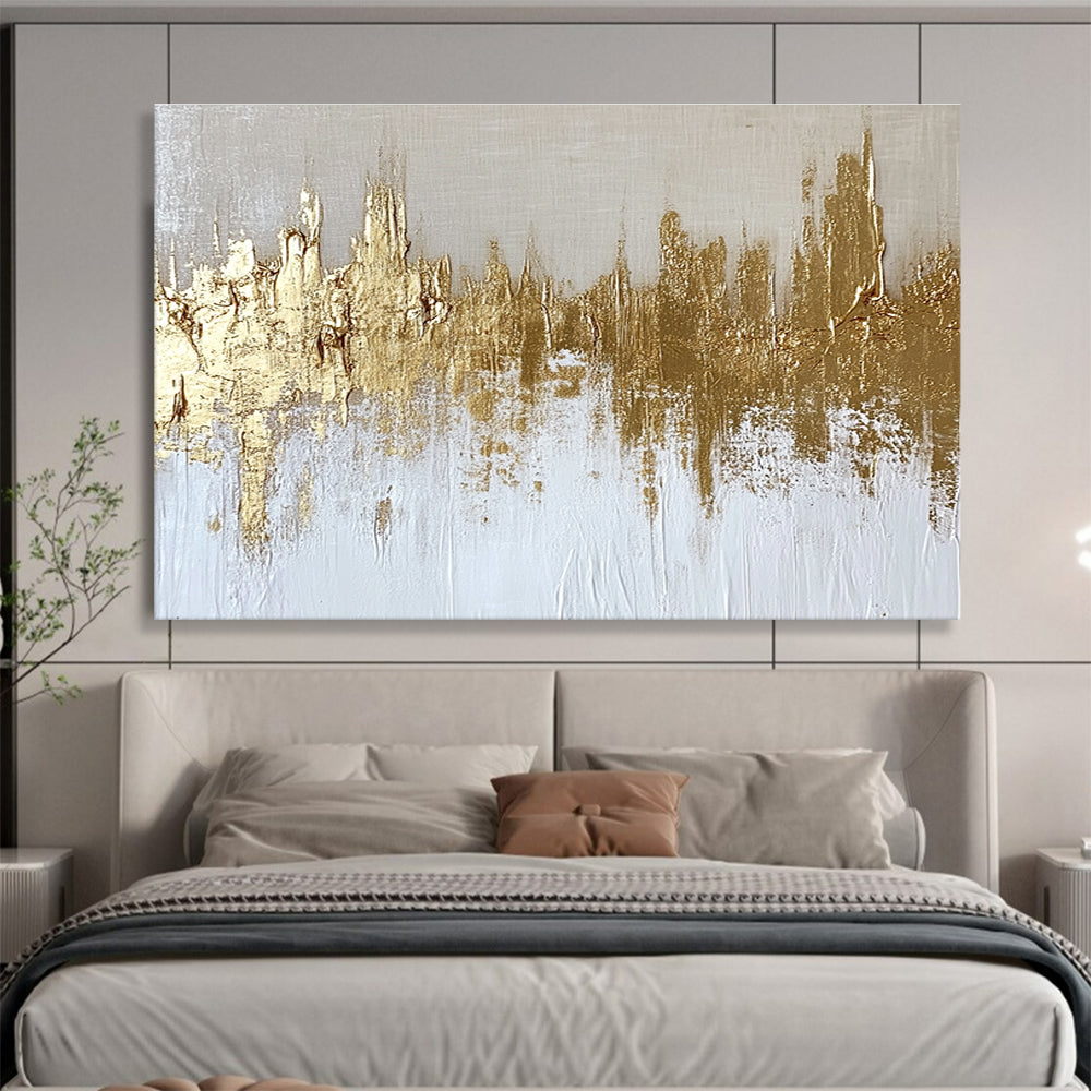 Large abstract painting of a gold and white cityscape with textured canvas and gold foil accents on a neutral background.SC173