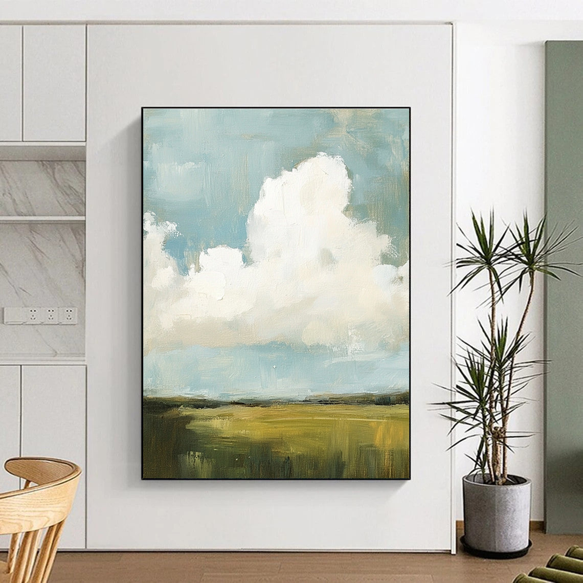 Large abstract painting featuring fluffy white and gray clouds over green grass fields with visible brush strokes and muted colors, creating a detailed scene.STSC873