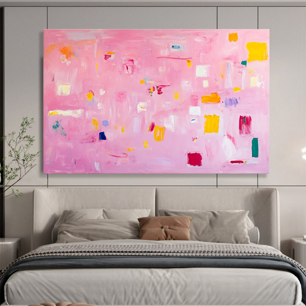 A large abstract painting featuring soft pink hues bright yellow blocks red lines and white squares creates a joyful warm atmosphere perfect for celebration.SC536