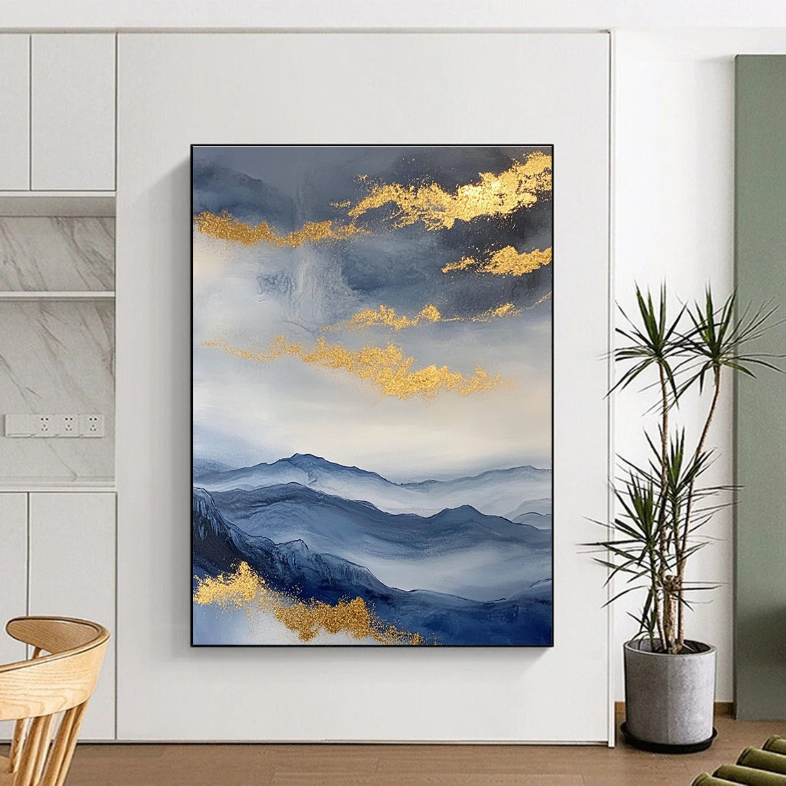Large abstract painting featuring a beautiful sky mountains and clouds in blue and gray with gold foil accents.STSC279