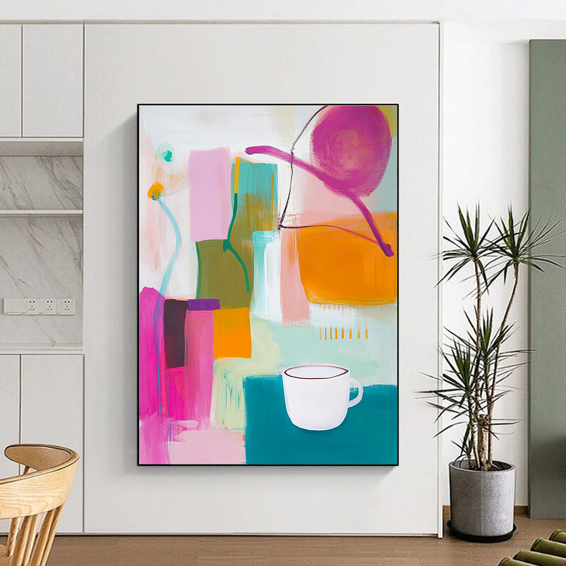 An abstract painting features vibrant pink green and yellow shapes with an orange object and a white cup on top alongside blue and purple lines.STSC787
