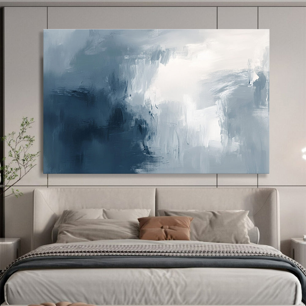 Large abstract painting with broad brush strokes in gray white and navy blue evoking calmness and introspection through soft gradients.SC048