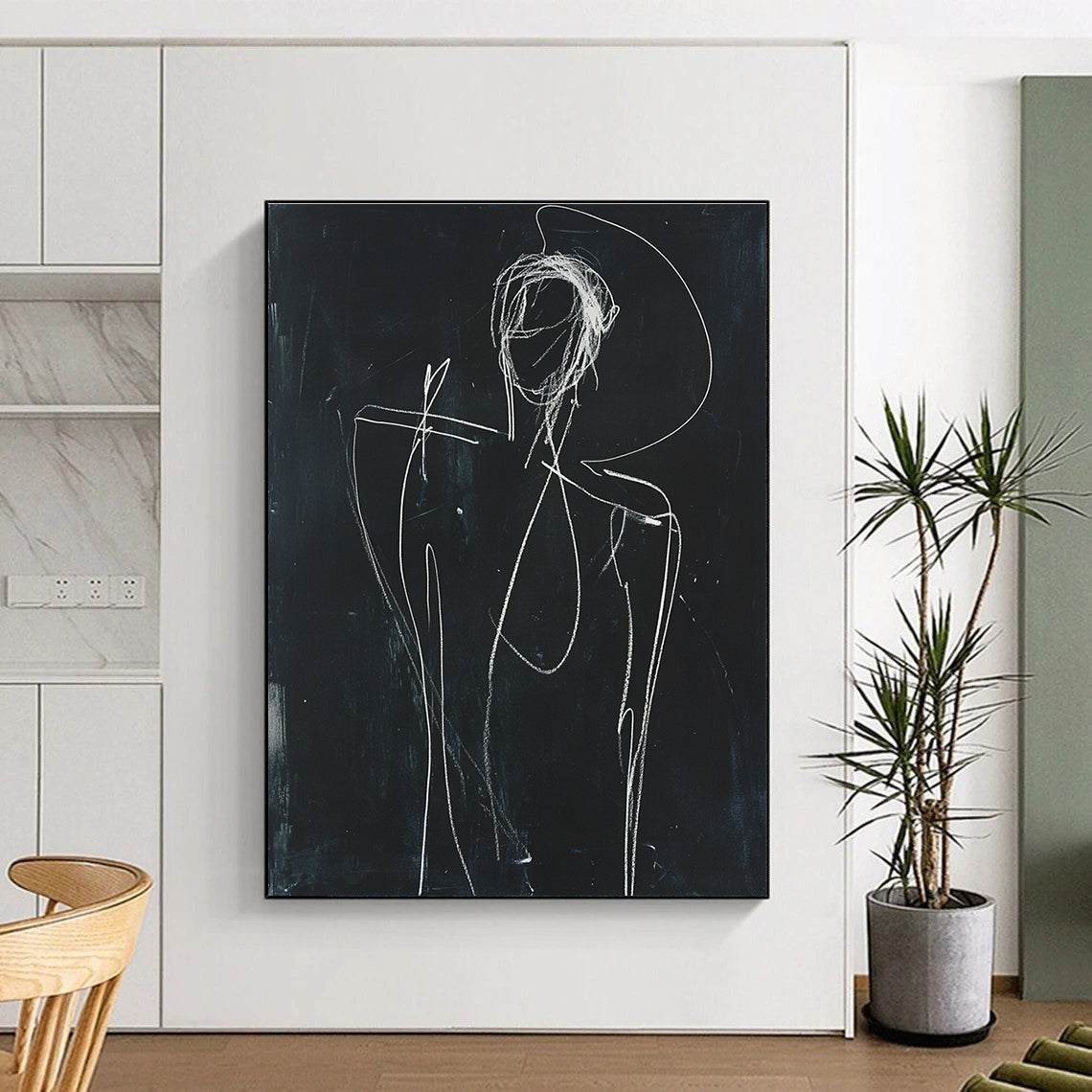 A large abstract sketch depicting a human figure in white chalk on black paper with raised arm and minimalist facial opening.STSC977