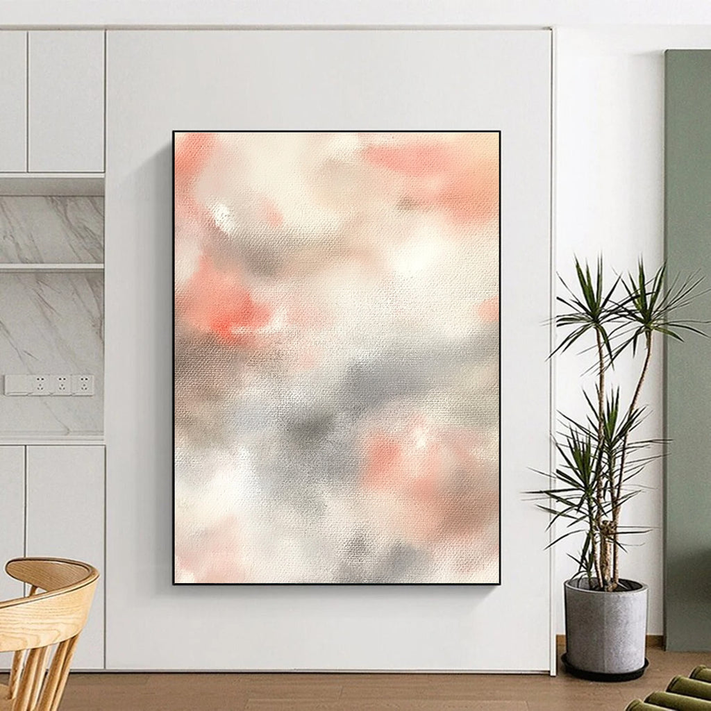 Large abstract painting featuring soft pinks whites and light gray clouds on a beige background creating a serene atmosphere.STSC1462