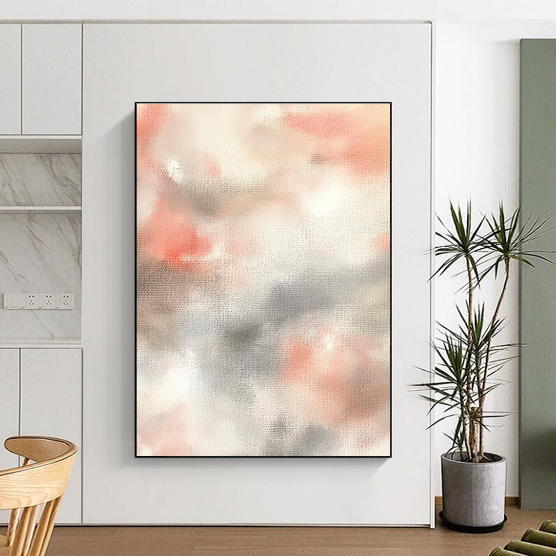 Large abstract painting featuring soft pinks whites and light gray clouds on a beige background creating a serene atmosphere.STSC1462