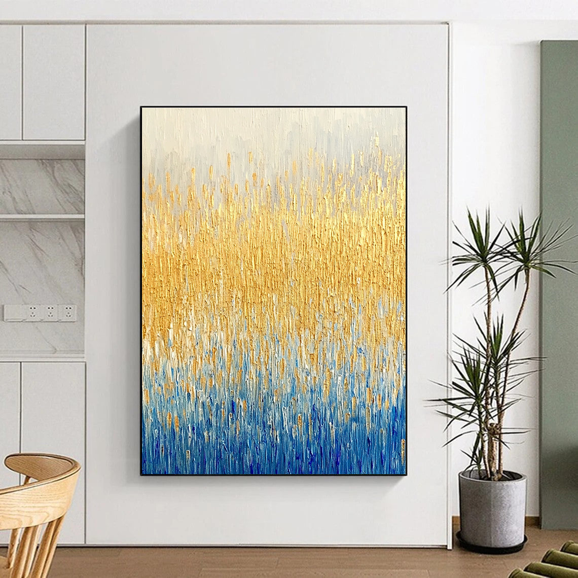 Large abstract painting of a textured wheat field in gold and blue hues showcasing fine art style and neutral tones.STSC291