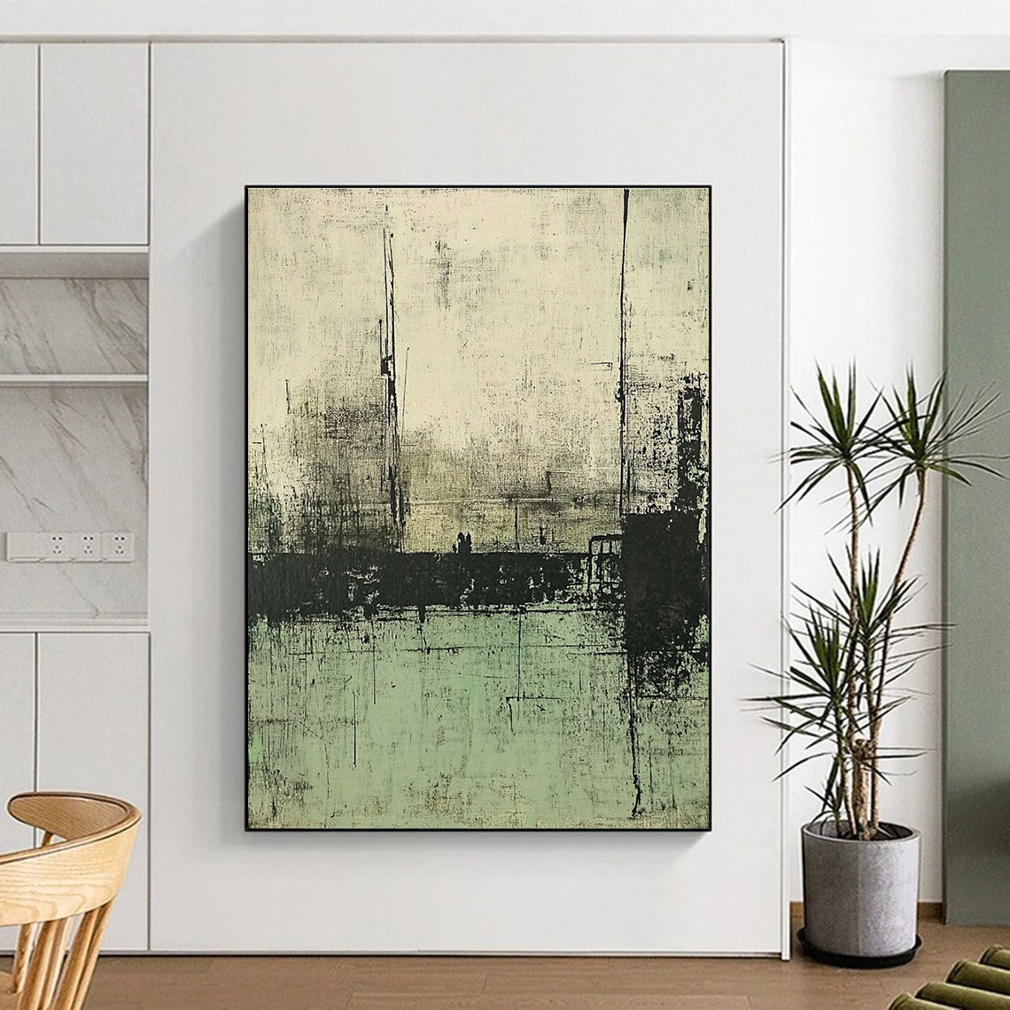 Large abstract painting featuring muted green and gray tones depicting a desolate landscape with distant buildings and water.STSC421
