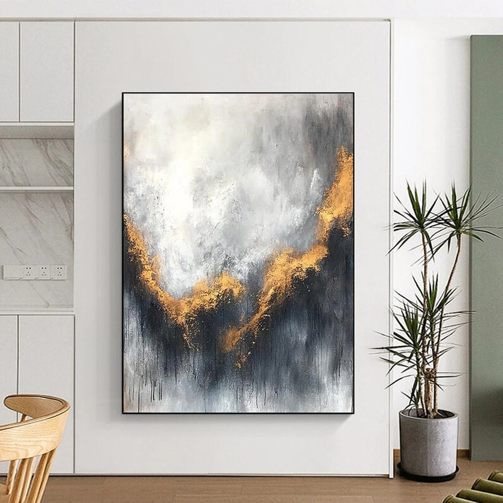 Large abstract painting with gray and white background golden accents atmospheric clouds and soft edges evokes calmness and introspection.STSC397
