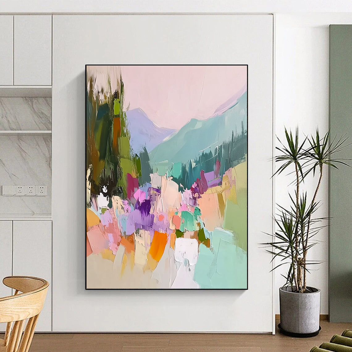 Large abstract painting featuring vibrant colors with trees flowers and mountains showcasing thick brush strokes and textured canvas in a harmonious light pink sky.STSC104