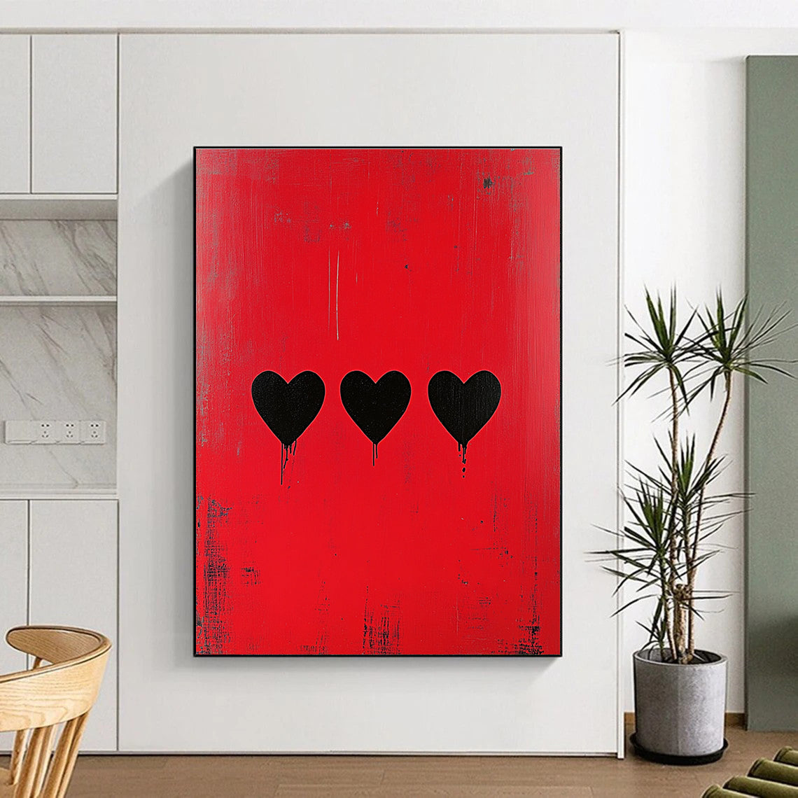 Large abstract painting with a striking red background featuring three bold black hearts in a style reminiscent of Banksy.STSC1164