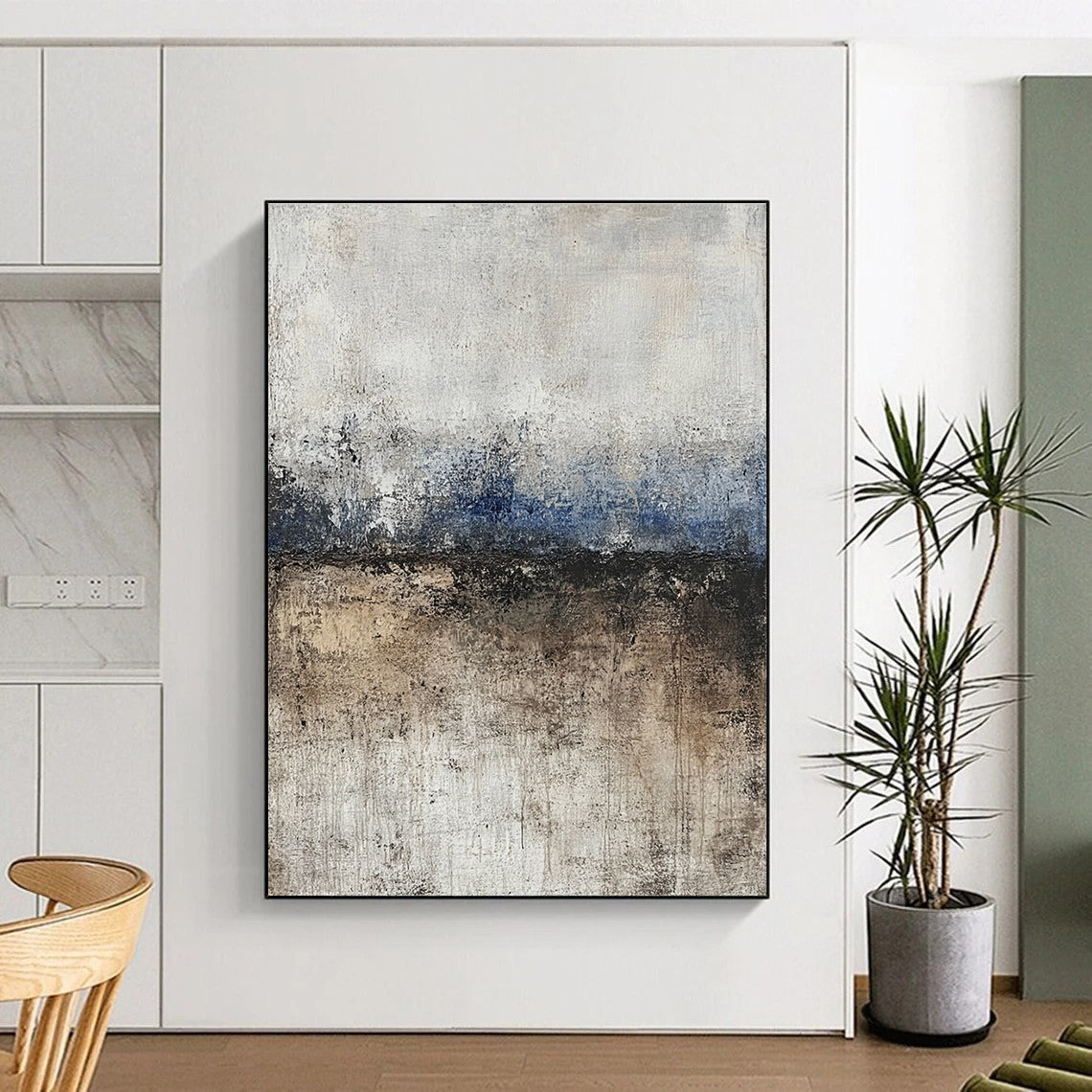 Large abstract painting featuring soft edges and subtle color transitions of beige blue-gray and brown with a path leading to tranquil water.STSC125