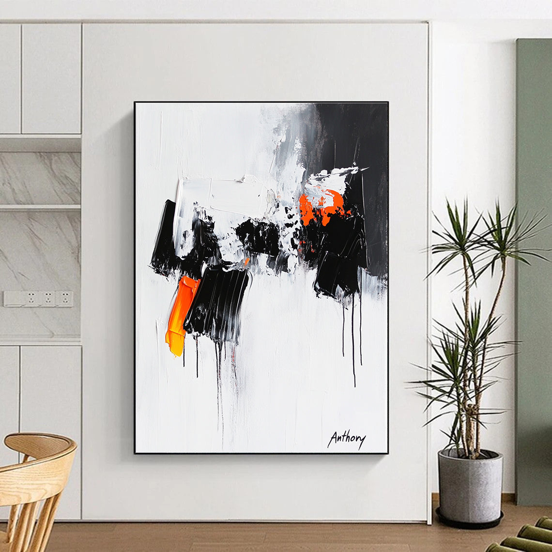 Large abstract painting featuring the word Anthony with black and orange dripping paint thick brush strokes and bold black shapes on a white background.STSC350