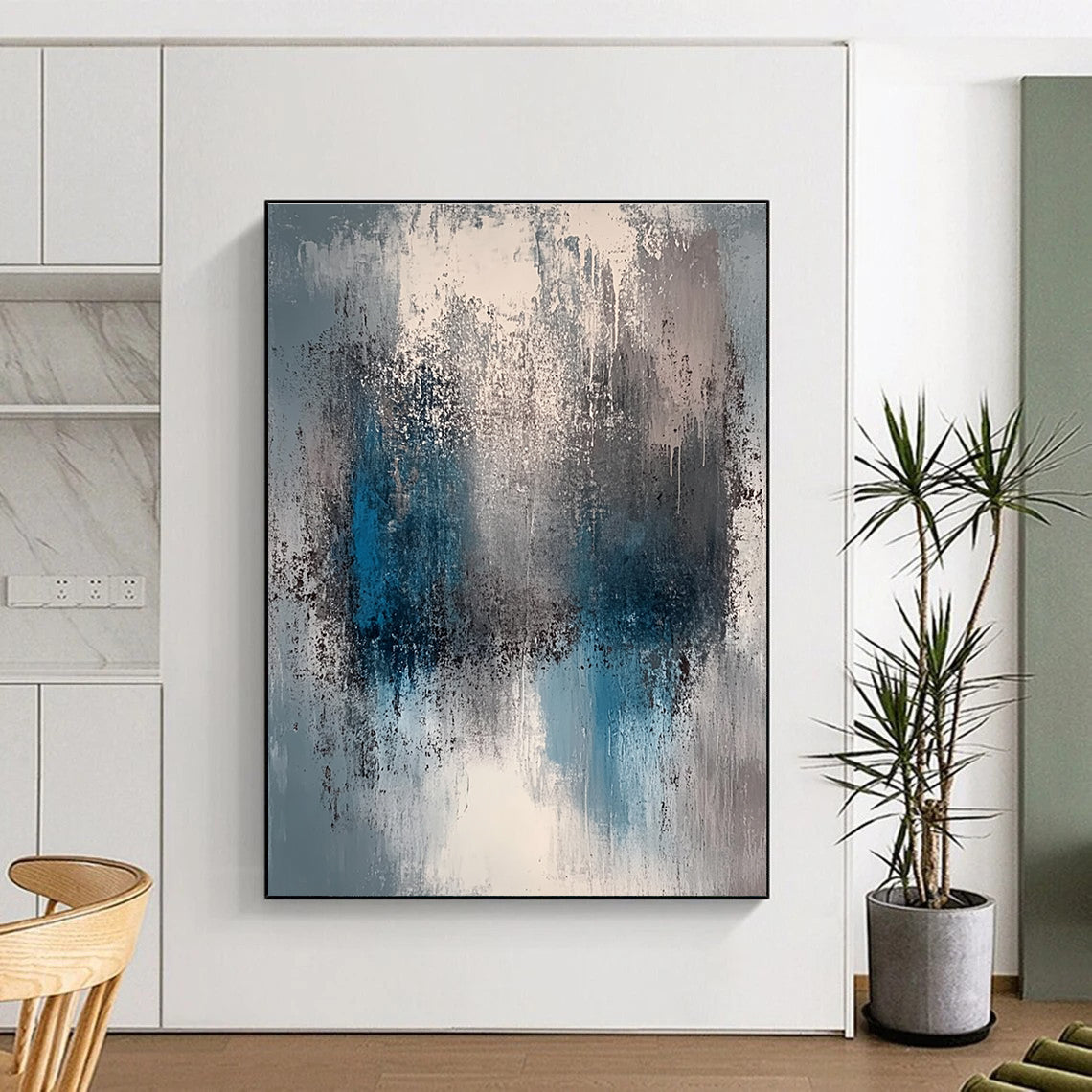 A large abstract painting featuring a faded gray and blue color palette with soft lighting and neutral tones.STSC577