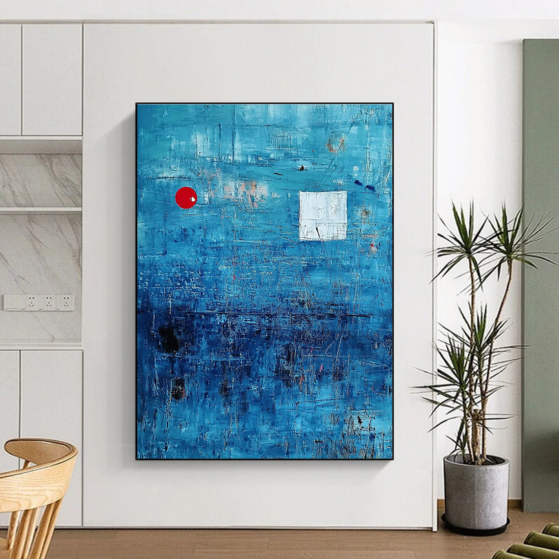 Large abstract painting featuring a serene blue ocean with textured brush strokes and dynamic black lines, accented by a small red circle and white squares.STSC041