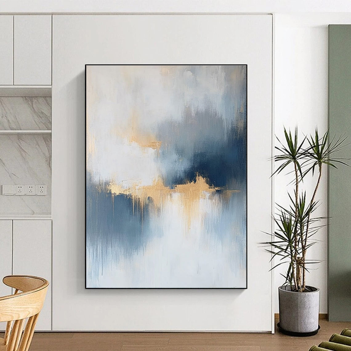 Large abstract painting featuring atmospheric clouds in soft blue gray and white tones with gold and silver accents and delicate textures.STSC386
