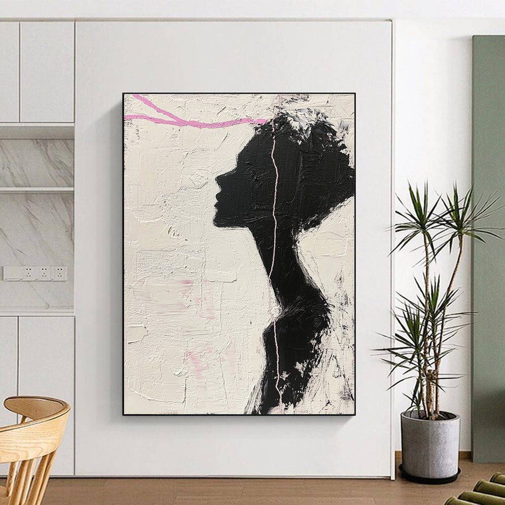 Large abstract painting in black and white featuring a woman’s silhouette with pink accents enhancing her facial features against a textured background.STSC1091
