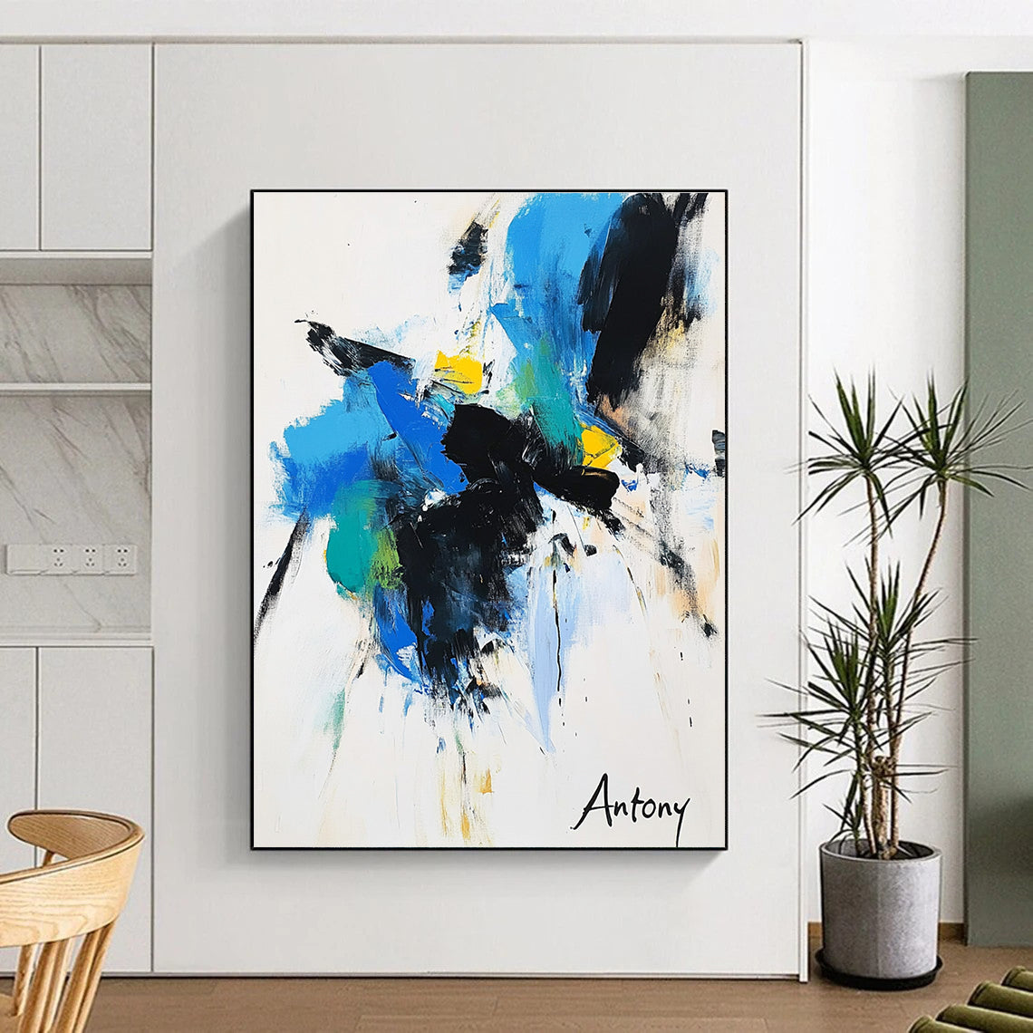 Abstract painting features bold black brush strokes with blue green and yellow accents on a white background with Antony elegantly displayed in large letters.STSC039