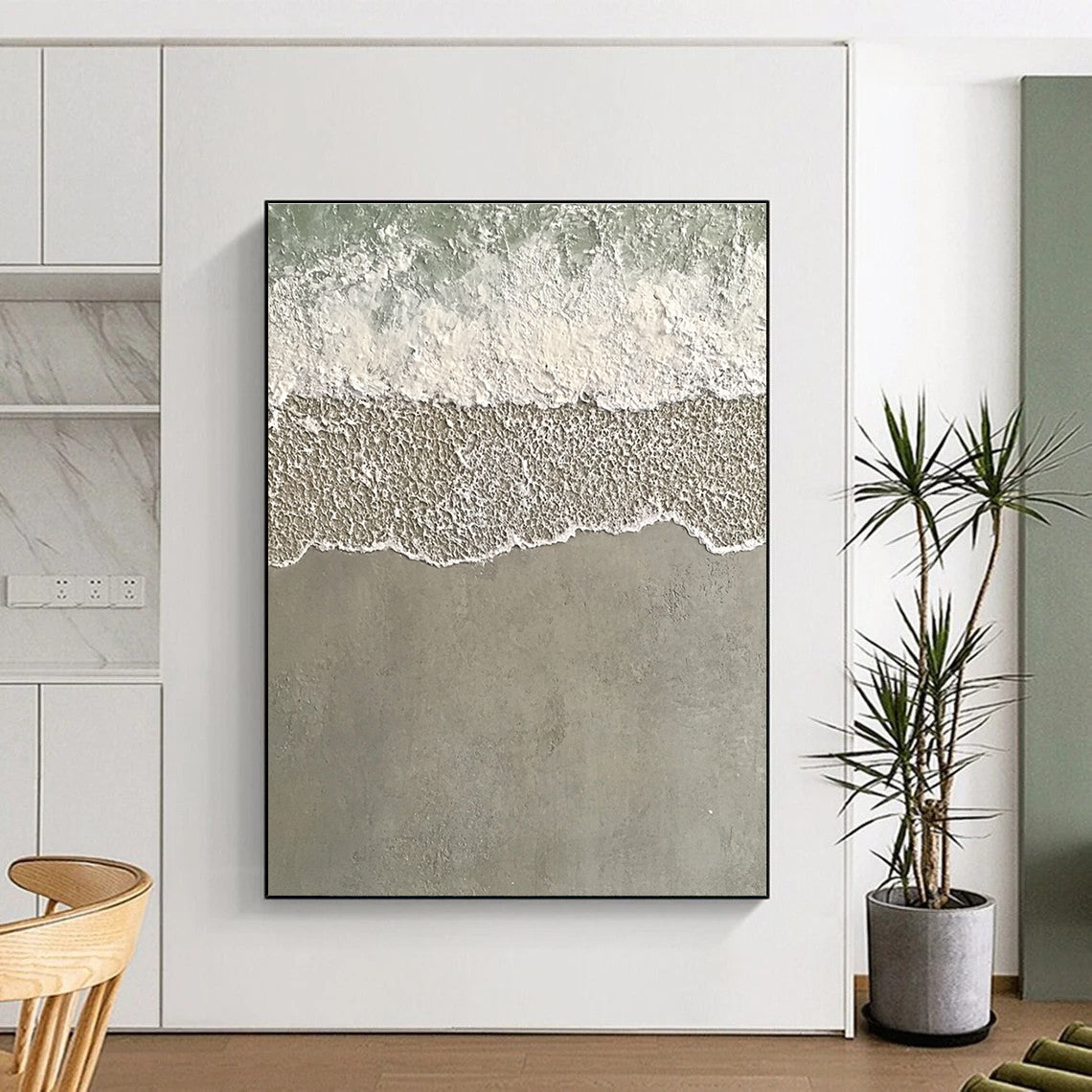 Large abstract painting depicting serene water and sand with textured wave patterns in light green and grayish-white tones.STSC1136