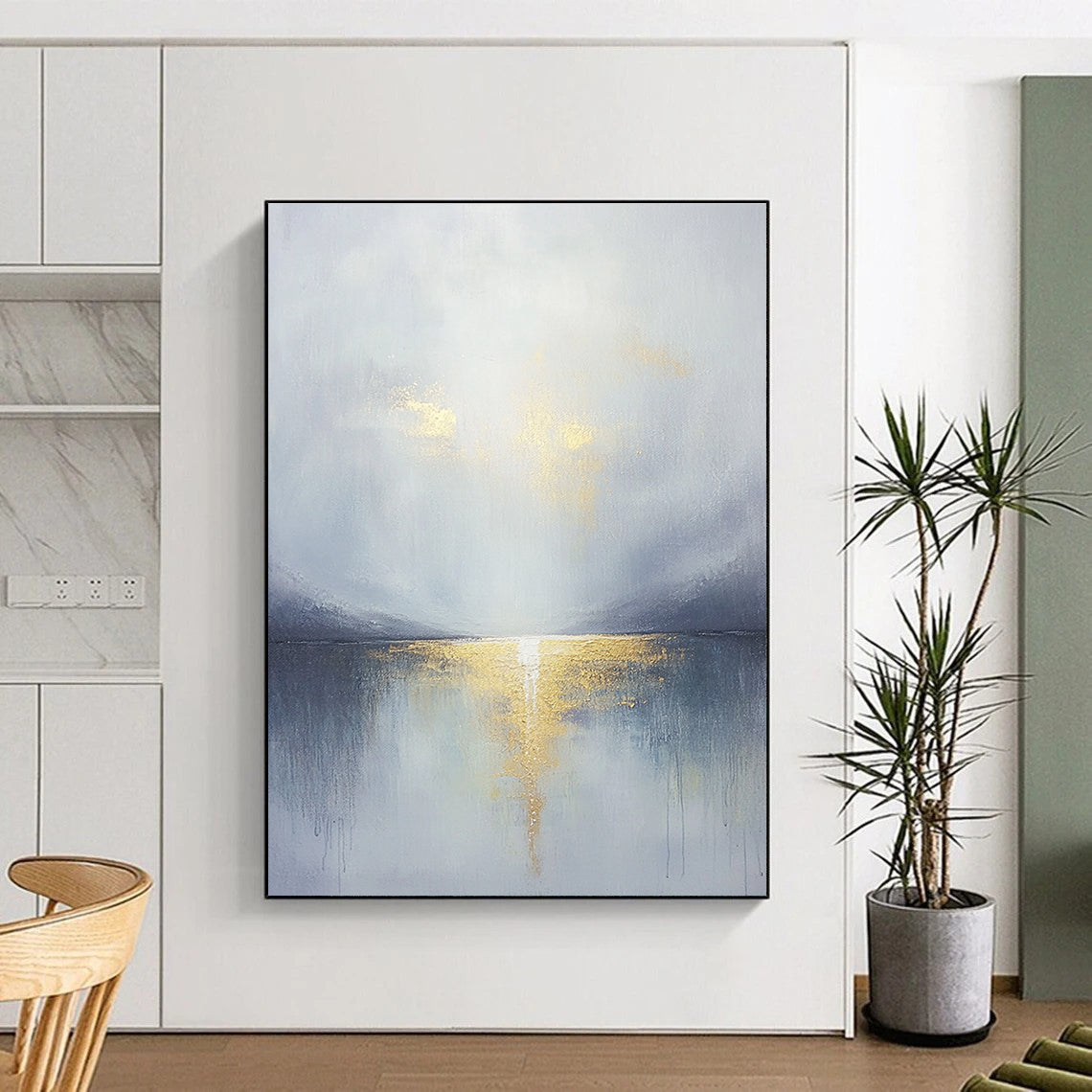 Large abstract painting featuring a grey sky clouds gold horizon and a tranquil lake in the foreground with soft muted colors.STSC289