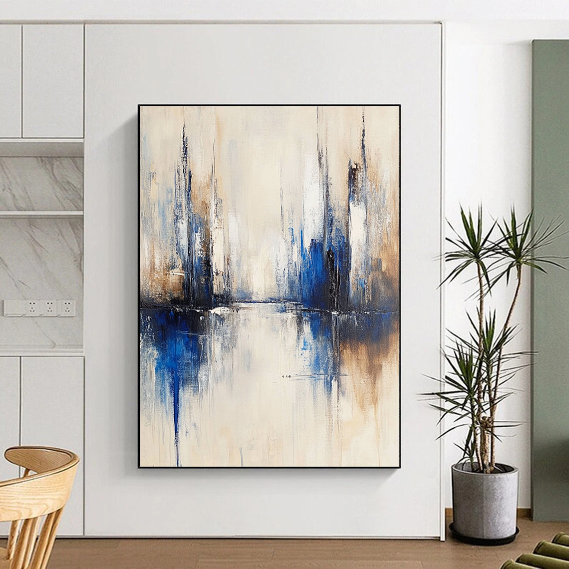 Large abstract painting of a city with muted white and blue tones on a beige background featuring blurred brush strokes reflecting in water.STSC134