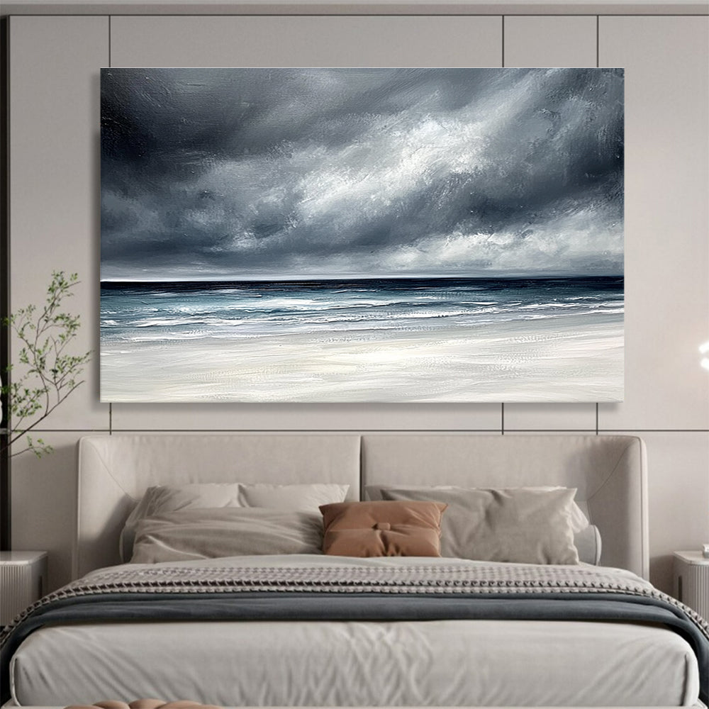 Large abstract painting featuring an ocean with stormy gray clouds and a white sand beach in soft gray and blue tones.SC163