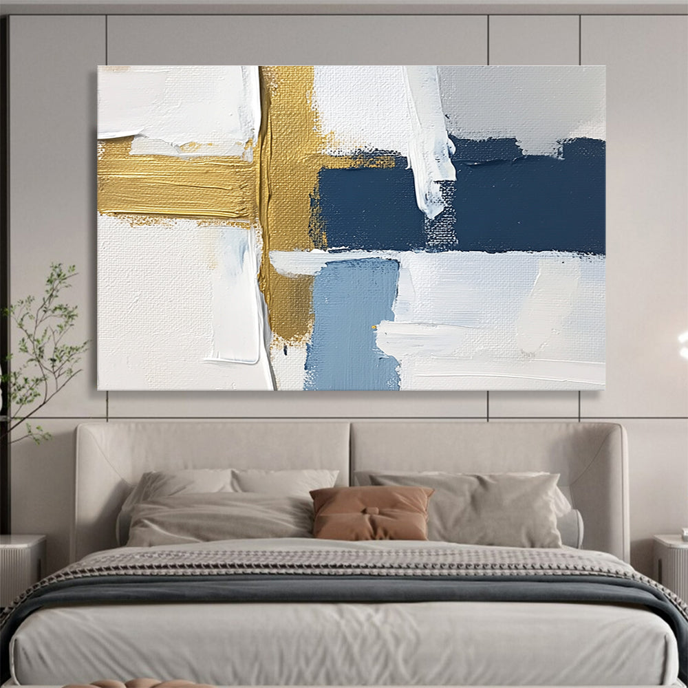 Large abstract painting with white blue and gold blocks featuring brushstrokes and texture showcasing a golden cross for depth in a serene atmosphere.SC267