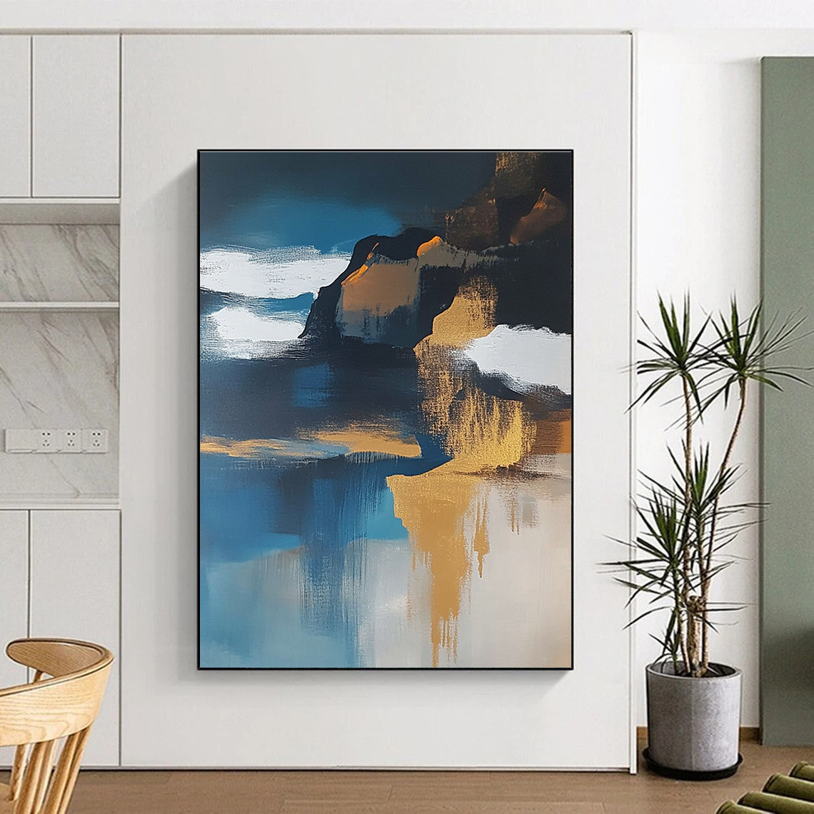 Large abstract painting of an island featuring navy blue water white clouds brown sand and gold leafing exuding a sense of calmness.STSC651