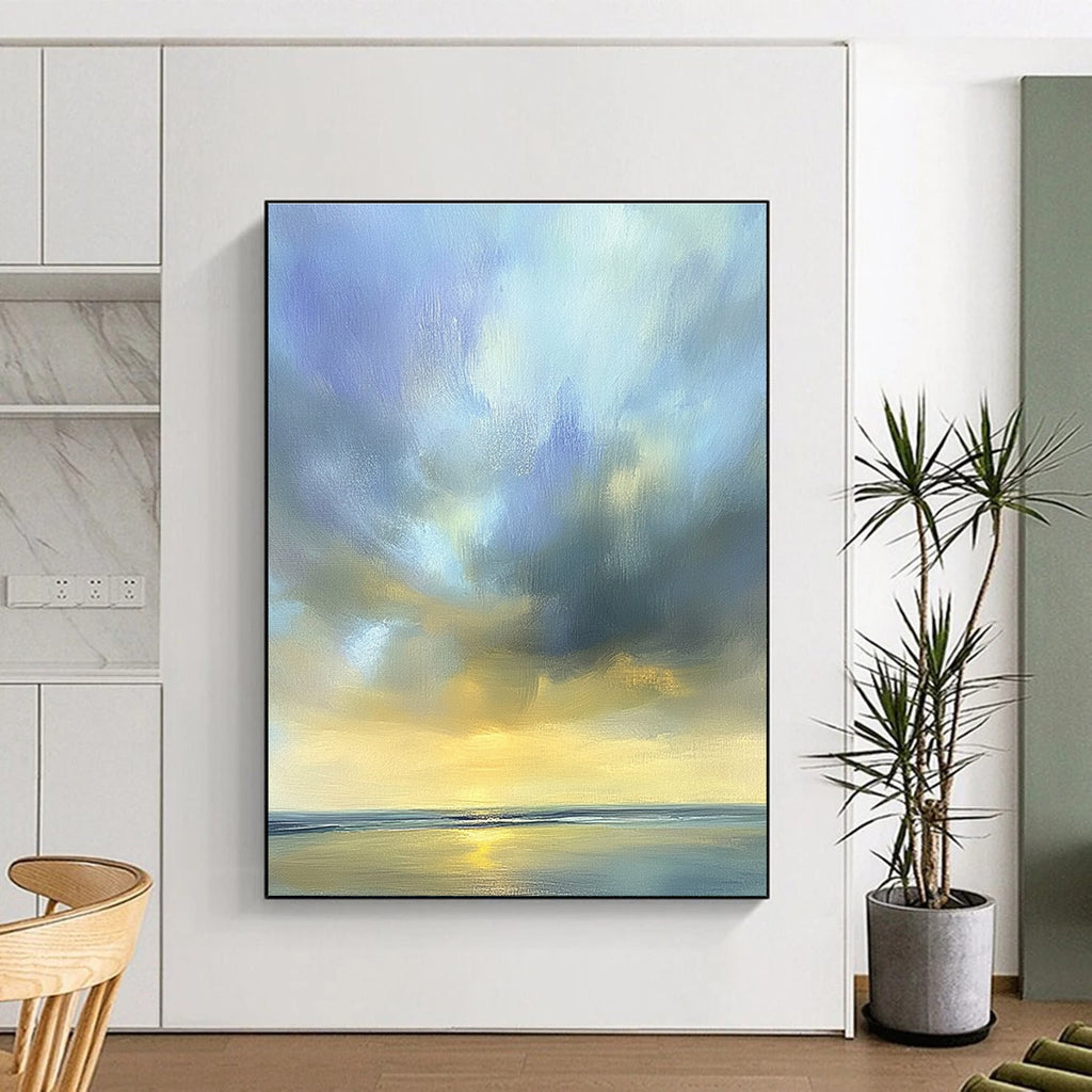 Large abstract oil painting of the sky featuring muted blue light gray and soft clouds over an ocean horizon in beautiful serene colors.STSC201