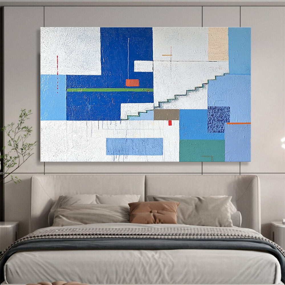A large abstract painting of an urban landscape in blue and white tones, featuring geometric buildings with green accents, stairs, windows, and doors.SC488