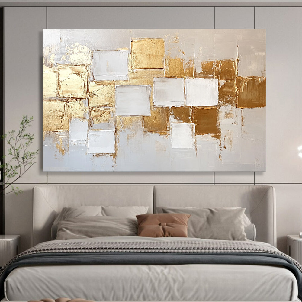 Large abstract painting in white and gold featuring textured square block patterns and soft lighting for an elegant touch.SC292