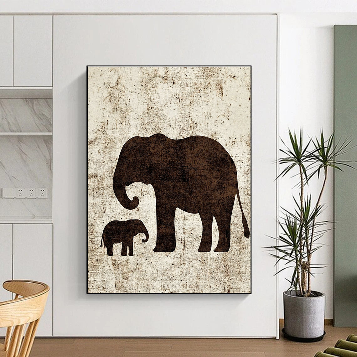 A large abstract artwork featuring minimalist silhouettes of an elephant and a baby elephant in textured brown ink on white paper.STSC1095