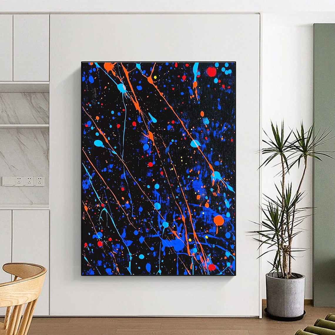 Large abstract painting featuring blue and black splatters with vibrant orange and red highlights for a dynamic artistic statement.STSC1406