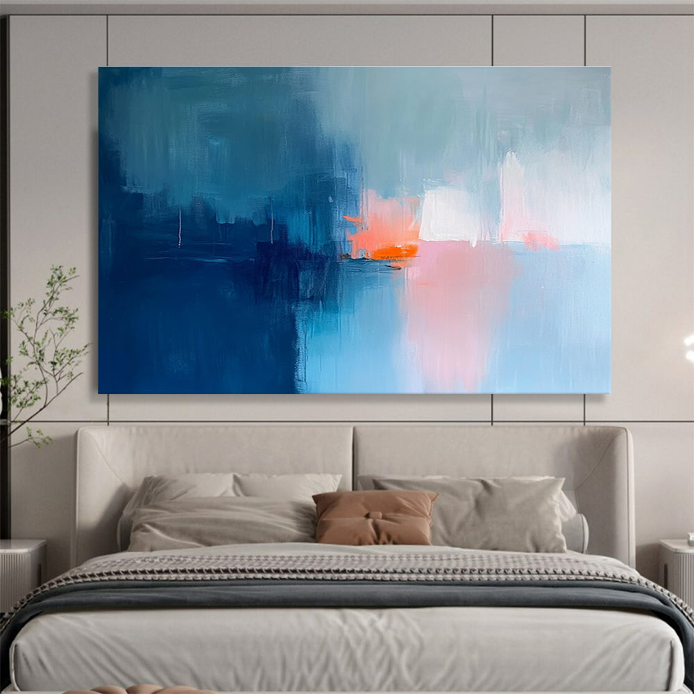 Large abstract painting in soft blue tones with pink and orange accents creates a serene mood through expressive brush strokes and blurred edges.SC253