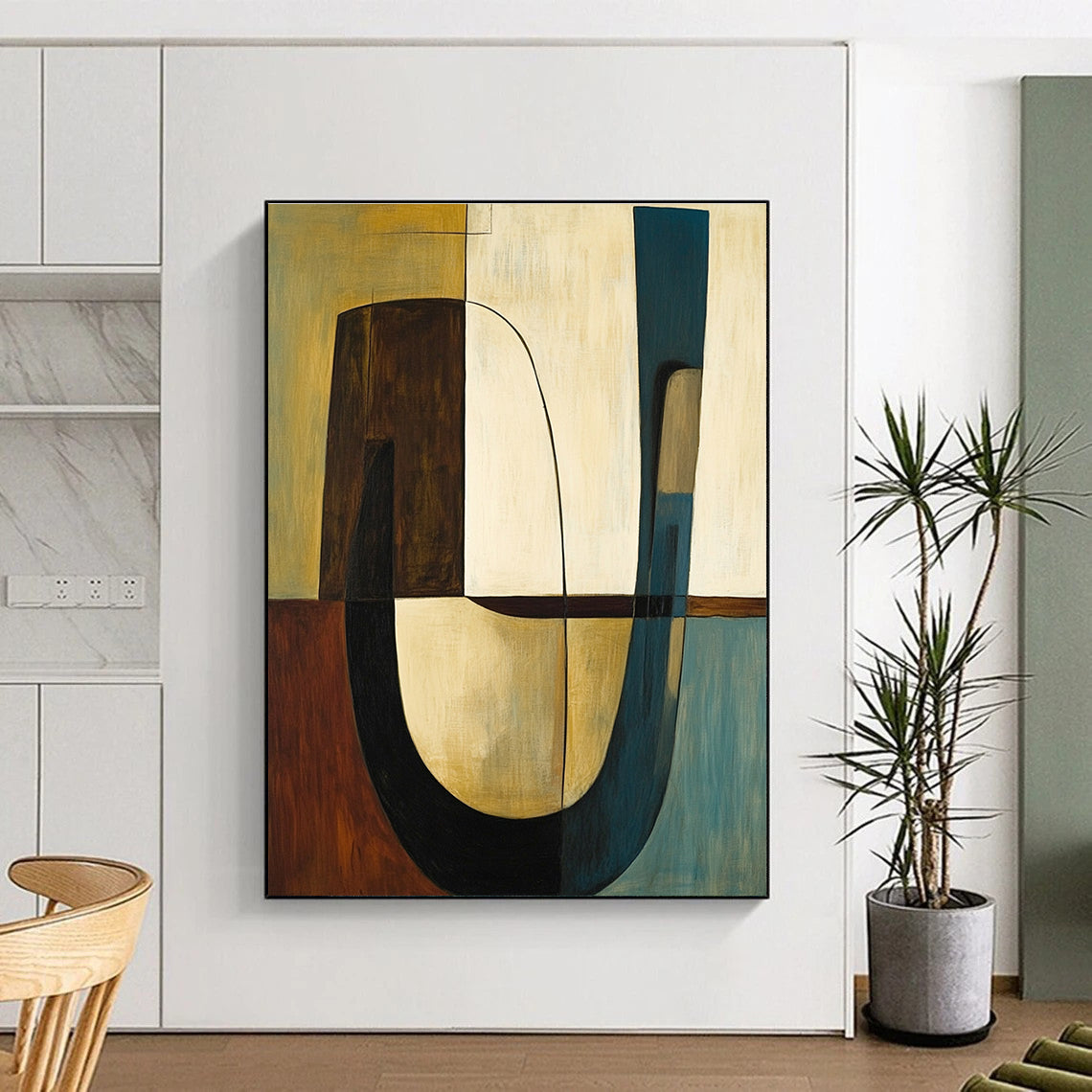 Abstract painting featuring shapes and lines in olive green with brown accents complemented by a large curved table and two chairs.STSC693